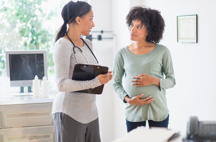Doctor talking to pregnant patient